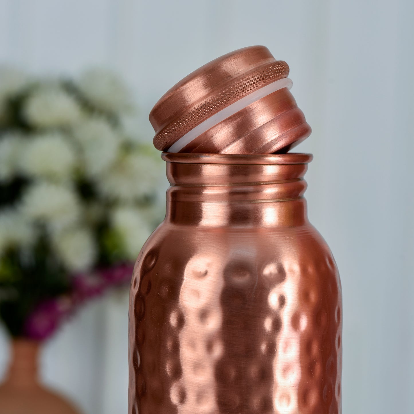100% Pure Ayurvedic Copper Water Bottle with hammered design and leak-proof cap by LIVINGNISH, ideal for natural wellness and daily hydration.