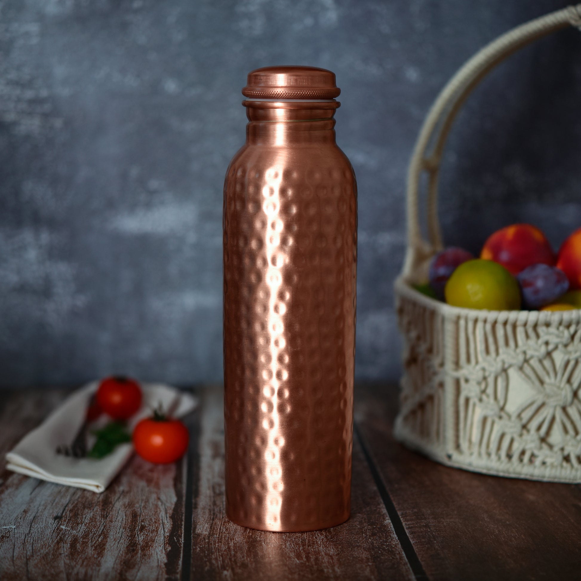 Classic 100% Pure Copper Water Bottle- 34 OZ with hammered finish, ideal for yoga, fitness, and eco-conscious hydration in kitchen or dining spaces.